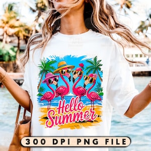 May include: A white t-shirt with a graphic of four pink flamingos wearing sunglasses and hats. The flamingos are standing on a beach with palm trees and the text "Hello Summer".
