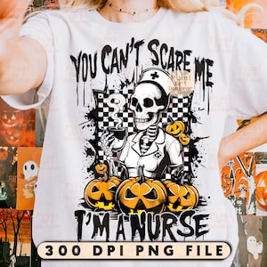 May include: White t-shirt with a Halloween-themed graphic. The design features a skeleton dressed as a nurse holding a cup, surrounded by pumpkins. Text reads "YOU CAN'T SCARE ME I'M A NURSE".