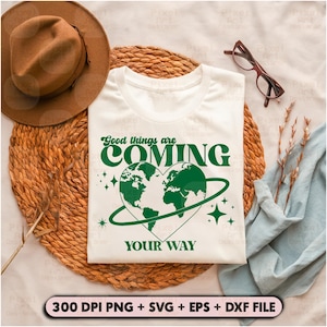 May include: A white t-shirt with a green graphic of a heart-shaped earth with the text "Good things are COMING YOUR WAY" in green letters.