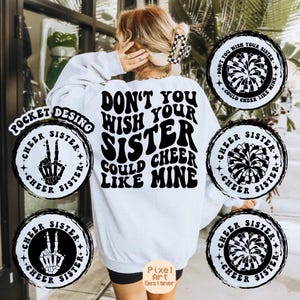 May include: White sweatshirt with black text that reads "Don't you wish your sister could cheer like mine."  Four black and white circular designs with the text "Cheer Sister" surround the sweatshirt.