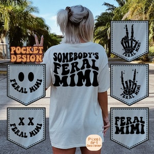 May include: A white t-shirt with the text "Somebody's Feral Mimi" printed on the back. The shirt has a pocket on the front with different designs, including a smiley face, a peace sign, a rock and roll hand gesture, and the text "Feral Mimi".
