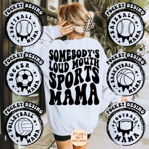 May include: White sweatshirt with black text that reads "Somebody's Loud Mouth Sports Mama".  The sweatshirt has seven black and white circular designs around the edges, each with a different sport ball and the text "Pocket Desing" and "Mama".