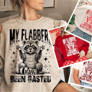 May include: A beige sweatshirt with a black graphic of a raccoon with the text "My flabbers have been gasted".