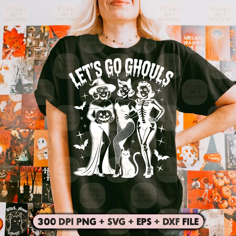 May include: Black t-shirt featuring the text "LET'S GO GHOULS" and a graphic of three women in Halloween costumes. The design includes a witch, a woman in a dress, and a skeleton, along with bats and a cat. The bottom of the image includes text.