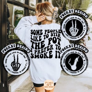 May include: White sweatshirt with black text that reads "Some people like to stir the pot I prefer to smoke it". The text is in a retro font. There are two black and white circular designs on the sweatshirt, one with a skeleton hand making a peace sign and the other with a bong.