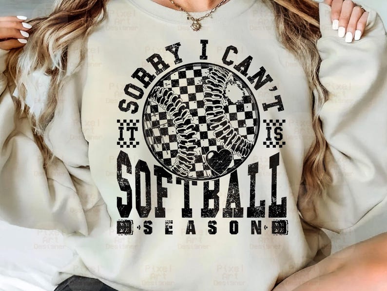 May include: A white sweatshirt with black text that reads "Sorry I Can't It Is Softball Season" with a black and white checkered softball graphic.