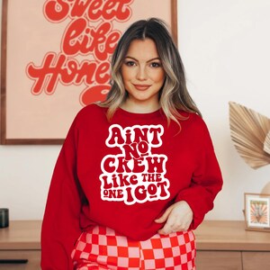 May include: Red sweatshirt with white text that reads "Ain't No Crew Like The One I Got".