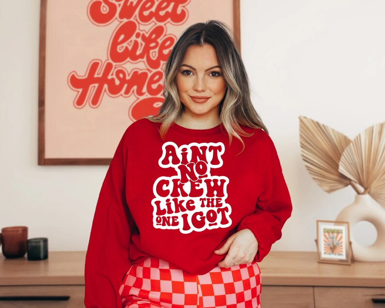 May include: Red sweatshirt with white text that reads "Ain't No Crew Like The One I Got".