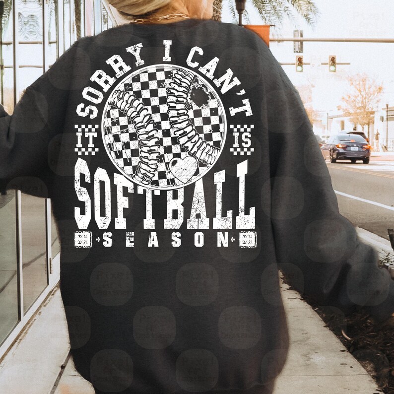 May include: A black sweatshirt with a white graphic design that says "Sorry I can't it is softball season". The graphic features a checkered softball with a heart in the center.