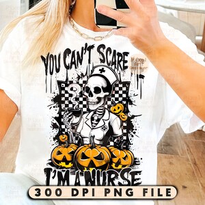 May include: White t-shirt with a Halloween-themed graphic. The design features a skeleton in a nurse's uniform holding a coffee cup, surrounded by pumpkins. Text reads "YOU CAN'T SCARE I'M A NURSE" and "300 DPI PNG FILE".