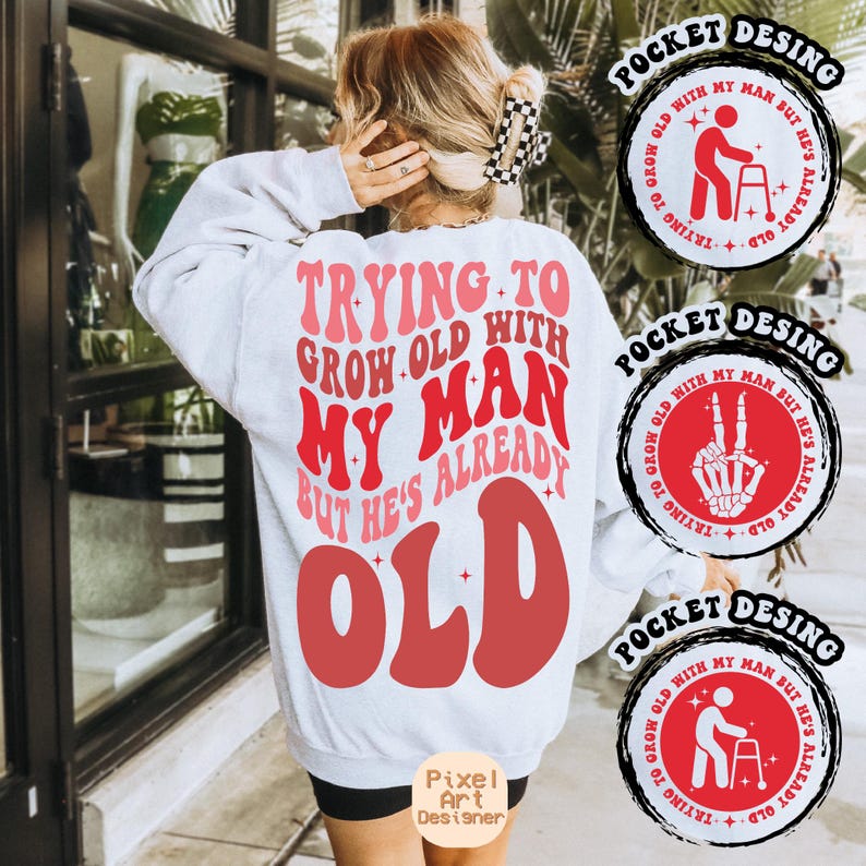 May include: White sweatshirt with a red and pink graphic that says "Trying to grow old with my man but he's already old". The graphic is in a retro font style. There are three pocket designs on the image, each with a different graphic. The pocket designs are in black and red.