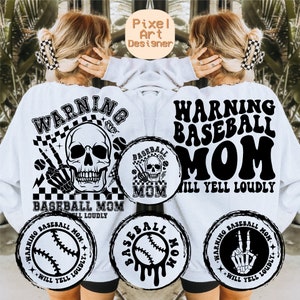 May include: A white sweatshirt with a black graphic design that says "Warning Baseball Mom Will Yell Loudly". The design includes a skull, baseballs, and a peace sign.