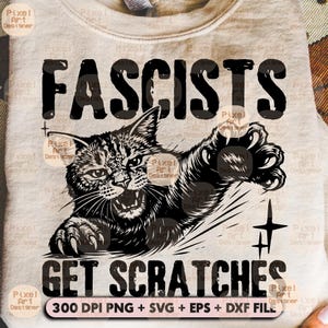 May include: A light beige sweatshirt with the words "FASCISTS GET SCRATCHES" in black, featuring a black and white illustration of an angry cat swiping with its claws. The bottom of the image includes text: "300 DPI PNG + SVG + EPS + DXF FILE".