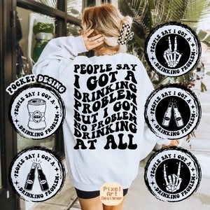 May include: White sweatshirt with black text that reads "People say I got a drinking problem but I got no problem drinking at all". The text is in a retro font. There are four black and white circular designs around the text, each with the words "People say I got a drinking problem". The designs feature a beer can, two beer bottles, a skeleton hand giving the peace sign, and a skeleton hand giving the rock and roll sign.
