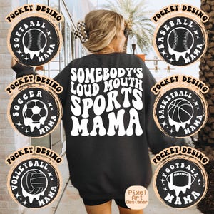 May include: Black sweatshirt with the text "Somebody's Loud Mouth Sports Mama" in white retro font. The sweatshirt has six different sports-themed pockets with a black and white design. Each pocket has a different sport: soccer, baseball, basketball, football, volleyball, and softball. Each pocket has the word "Mama" in white text.