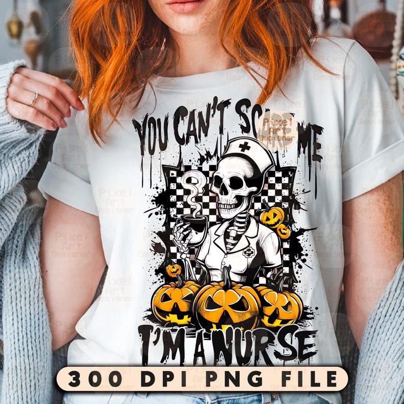 May include: White t-shirt with a Halloween-themed graphic. The design features a skeleton in a nurse's uniform holding a cup, surrounded by pumpkins. Text reads "You Can't Scare Me, I'm a Nurse."