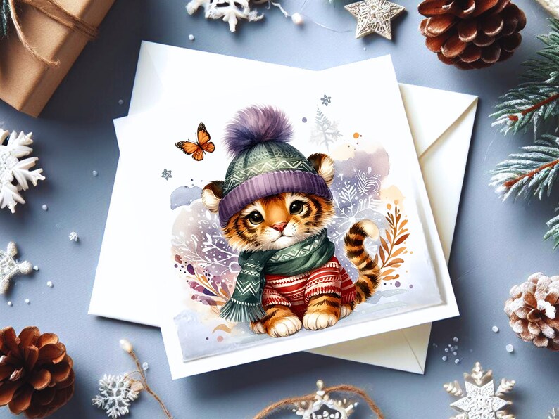 May include: A cute cartoon tiger cub wearing a purple and green knitted hat and scarf. The tiger is sitting on a snowy background with snowflakes and a butterfly.