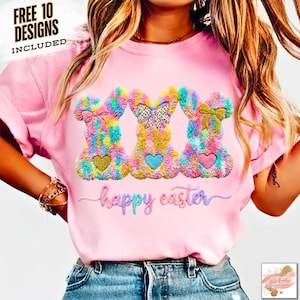 May include: A light pink t-shirt featuring three colorful bunny designs with bows and hearts. The words "happy easter" are embroidered below the bunnies. The top left corner of the shirt has the text "FREE 10 DESIGNS INCLUDED".