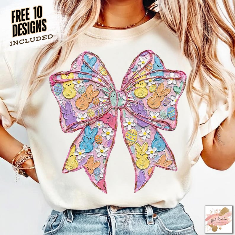 May include: A cream-colored t-shirt featuring a large, colorful bow design. The bow is decorated with Easter-themed elements like bunnies, eggs, and flowers in pastel colors. The text "FREE 10 DESIGNS INCLUDED" is printed at the top.