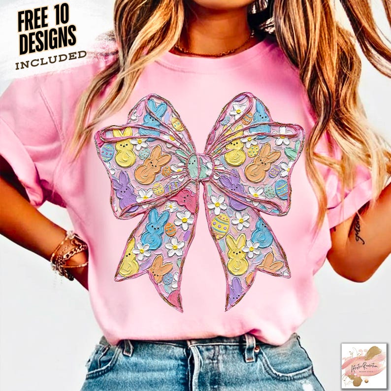 May include: Pink t-shirt featuring a large, colorful bow design with Easter-themed illustrations. The bow is adorned with bunnies, eggs, and flowers in pastel colors. The text "FREE 10 DESIGNS INCLUDED" is printed at the top.
