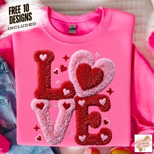 May include: A pink sweatshirt with the word "LOVE" in a textured, red and pink design. The letter "L" and "E" are red, and the letters "O" and "V" are pink. Small hearts and stars are scattered around the word. The text "FREE 10 DESIGNS INCLUDED" is in the upper left corner.