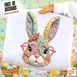 May include: A white square with an embroidered bunny face wearing heart-shaped glasses. The bunny has floral patterned ears and face, with pink and blue accents. The text "FREE 10 DESIGNS INCLUDED" is at the top left.