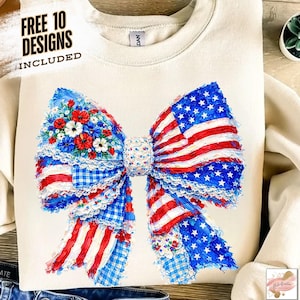 May include: Cream-colored sweatshirt featuring a large bow design in red, white, and blue, resembling the American flag. The bow is adorned with floral accents and gingham patterns. Text at the top reads "FREE 10 DESIGNS INCLUDED".
