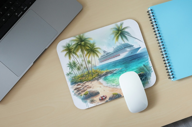 May include: A rectangular mousepad featuring a tropical beach scene with palm trees, a cruise ship, and a sandy shore. A white computer mouse is positioned on the mousepad. A laptop and a blue notebook are also visible.