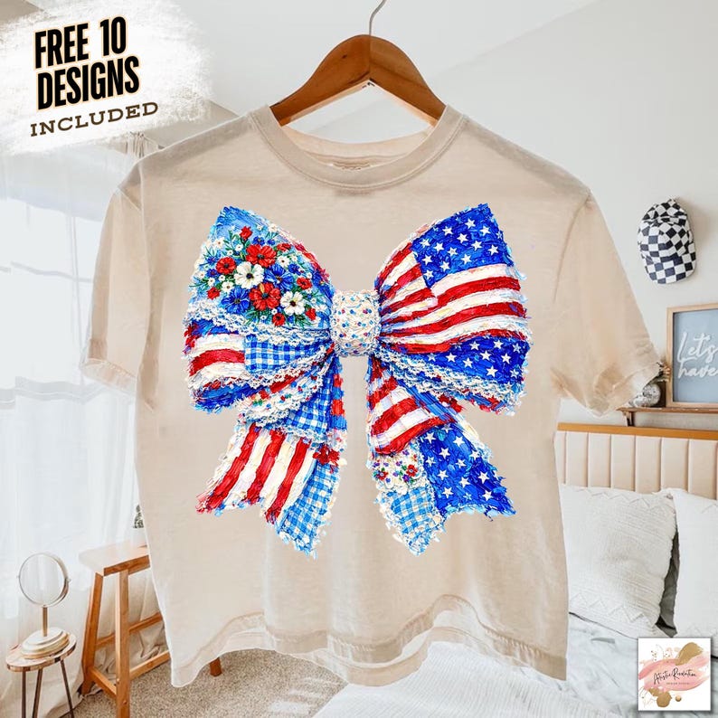 May include: A beige t-shirt featuring a large bow design with a patriotic theme. The bow incorporates elements of the American flag, floral patterns, and gingham. The text "FREE 10 DESIGNS INCLUDED" is visible in the upper left corner.