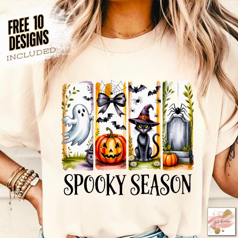 May include: Cream-colored t-shirt with a Halloween-themed design. The design includes a ghost, a bow, a jack-o'-lantern, a black cat in a witch hat, and a tombstone. The words "SPOOKY SEASON" are printed below the images. The text "FREE 10 DESIGNS INCLUDED" is printed at the top.