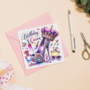 May include: A pink card with the text "Birthday Queen" in a decorative font. The card features a purple high-heeled shoe with a crown on top, surrounded by colorful jewels, perfume bottles, and makeup brushes.
