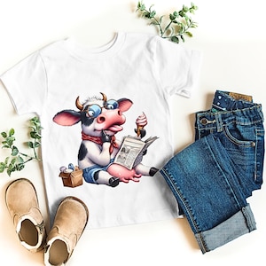 May include: White t-shirt featuring a cartoon cow wearing glasses and a red bandana, reading a newspaper and eating ice cream. The shirt is paired with blue jeans and tan boots, with a sprig of greenery on a white background.