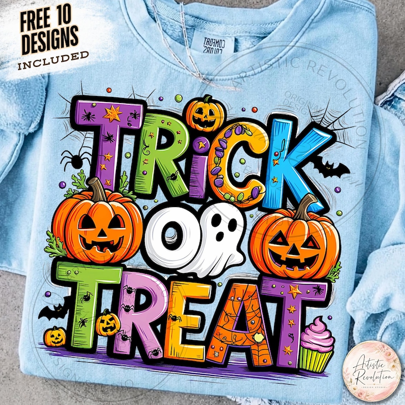 May include: A light blue sweatshirt featuring a colorful graphic with the text TRICK OR TREAT. The design includes orange jack-o'-lanterns, a white ghost, a pink cupcake, spiders, spiderwebs, and bats. The text FREE 10 DESIGNS INCLUDED is visible.