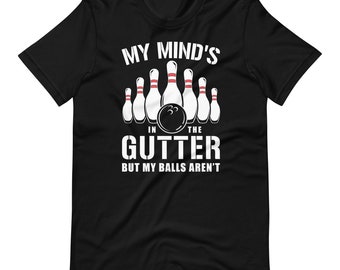 May include: Black t-shirt with a white graphic of bowling pins and a bowling ball. The text reads "My mind's in the gutter but my balls aren't."