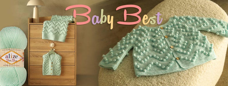 Puede incluir: Un c&aacute;rdigan de beb&eacute; verde menta con un dise&ntilde;o de punto de burbujas texturizado, junto con un gorro a juego. El c&aacute;rdigan tiene botones de madera. Tambi&eacute;n se ve un ovillo de lana Alize Baby Best. El texto "Baby Best" est&aacute; en la imagen.
