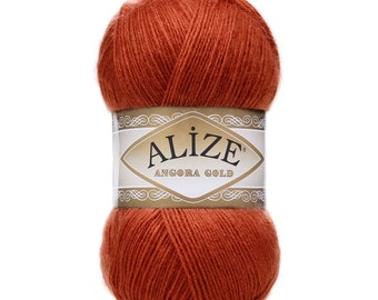 Puede incluir: Un ovillo de hilo de color óxido con una etiqueta que dice "Alize Angora Gold".