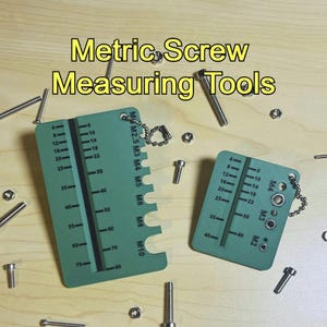 May include: Green metric screw measuring tools with a chain, surrounded by screws and nuts. The tools have measurements in millimetres and the text "Metric Screw Measuring Tools".