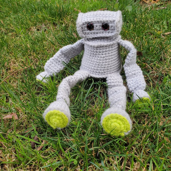 Small gray robot with bright green hands and feet
