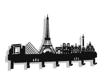 May include: Black metal key holder shaped like the Paris skyline, featuring iconic landmarks like the Eiffel Tower, Arc de Triomphe, and Notre Dame Cathedral. The holder has six hooks for hanging keys, coats, or other items.