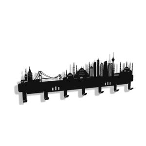 May include: Black metal wall-mounted coat rack featuring a silhouette of a city skyline. The design includes iconic landmarks and buildings, with several hooks for hanging items. The rack is a decorative and functional piece.