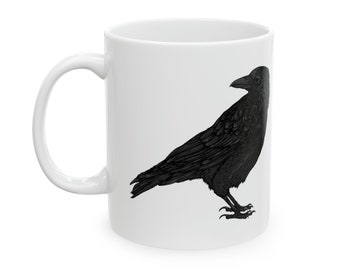 May include: White ceramic mug with a black silhouette of a crow on one side.