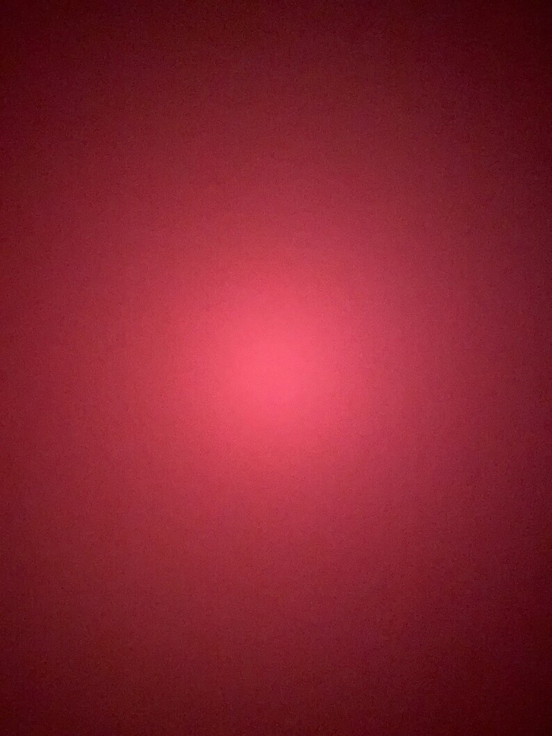 May include: A solid red background with a gradient effect, creating a soft, light red center.