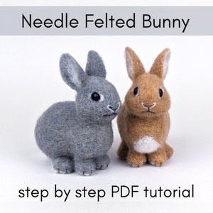 May include: Two needle felted bunnies, one gray and one brown, with white accents. The bunnies are standing on a white surface. The text "Needle Felted Bunny" is at the top of the image and "step by step PDF tutorial" is at the bottom.