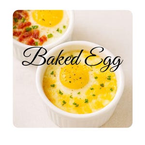 May include: Two white ramekins filled with baked eggs. The eggs have bright yellow yolks and are garnished with green herbs and bacon. The text "Baked Egg" is written in a cursive font across the image.