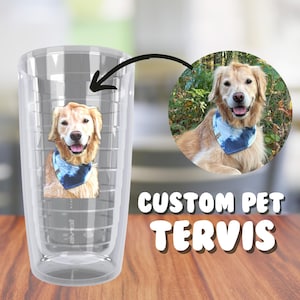 May include: A clear, reusable tumbler with a custom photo of a golden retriever wearing a blue bandana. The tumbler has a textured design and the words "CUSTOM PET TERVIS" are printed on the bottom.