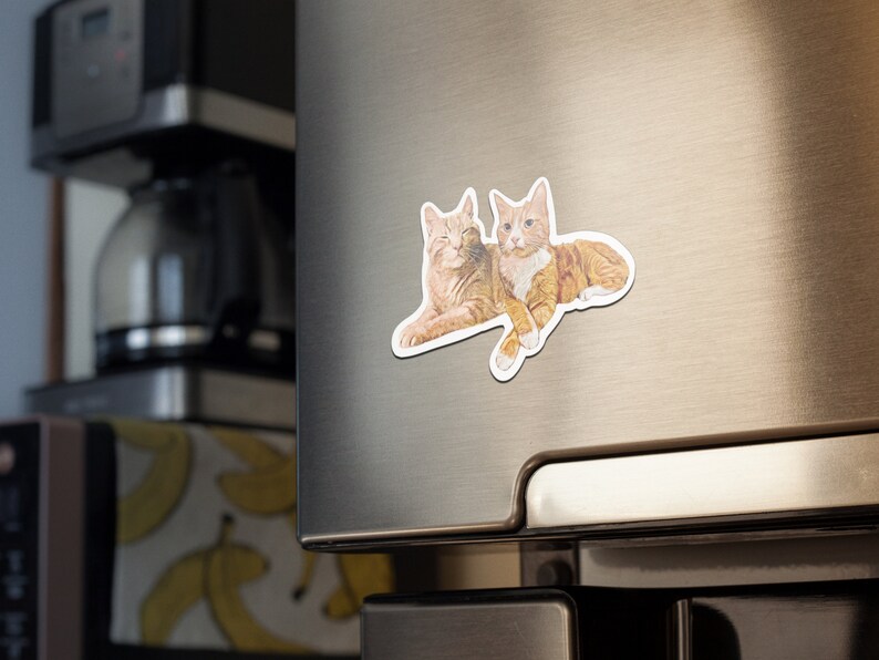 May include: Two orange tabby cats cuddling together on a white background. The cats are lying on their sides with their heads touching.