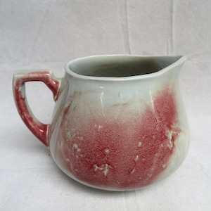 May include: A set of three ceramic mugs with a speckled, matte finish. The mugs are in shades of cream, light gray, and dark gray. Each mug has a simple, minimalist design, perfect for coffee or tea.