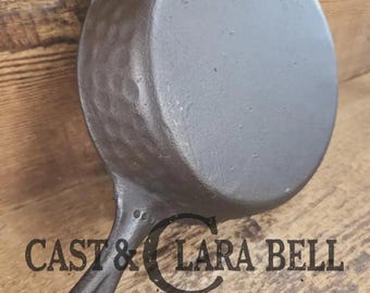 So cool! The "hammered ugly" #5 cast iron skillet.  Maker Unknown, great for sides!  SC24