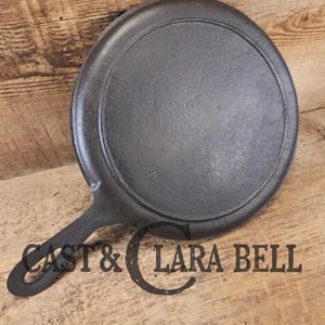 Piece of American history.  Late 1800's antique Gate marked Round Cast Iron Stove Eye Griddle.  Elegant and hard working. H Makers Mark