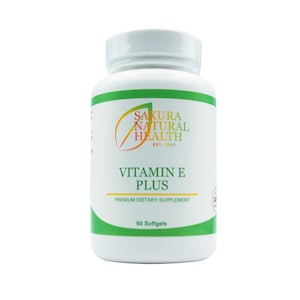May include: A white plastic bottle of Vitamin E Plus softgels. The bottle has a green and white label with the text "Sakura Natural Health" and "Vitamin E Plus". The bottle contains 60 softgels and is a premium dietary supplement.